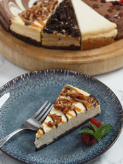 Turtle cheesecake on plate with fork