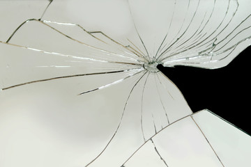 Broken mirror, glass with cracks and fallen large fragment