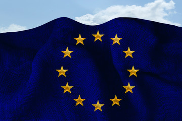 blue EU flag on a dense burlap lies on the background of blue sky