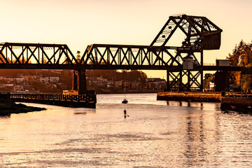 train bridge and paddleboarder at Ballard locks