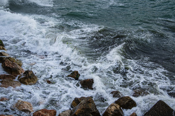 Seascape of dramatic storm, sea waves on wild rocky seashore