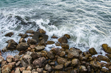 Seascape of dramatic storm, sea waves on wild rocky seashore
