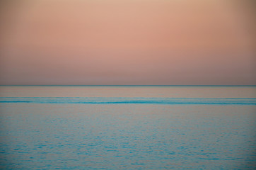 Seascape, view of sea horizon and colorful sky at sunset