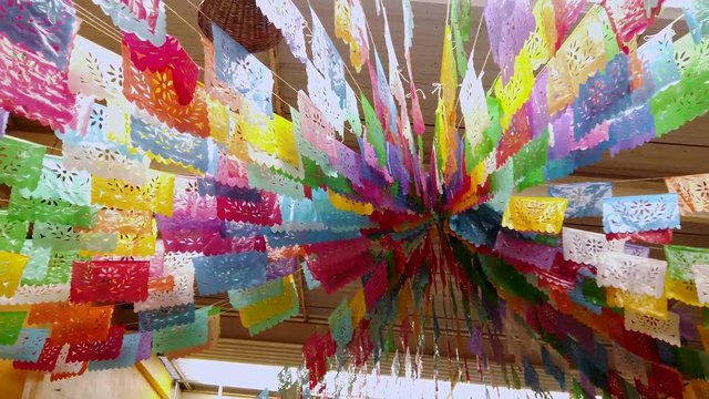 Folkloric decorations hanging from the sealing from a store in Puebla, Mexico.