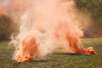 Two orange smoke grenades on the battlefield