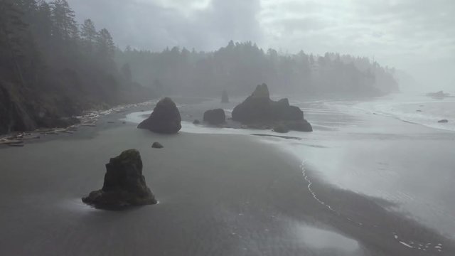 An orbiting aerial of Ruby Beach at low tide in Washington State's Olympic National Park.