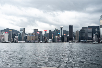 Naklejka premium Hong Kong / China - Feb 19 2019: Victoria harbour skyline panorama. Background skyscraper building of big city