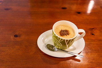 Cappuccino coffee on dark wood table 
