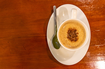Cappuccino coffee on dark wood table 