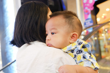 Child boy travel in super market with mother