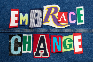 Fototapeta premium Colorful EMBRACE CHANGE word collage from cut out tee shirt letters on denim, skill development, horizontal aspect