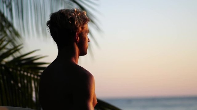 Happy care free confident surfer guy at sunset. Healthy Active Lifestyle. Surfing. Summer Vacation. 