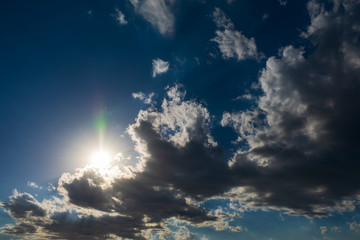 Fototapeta na wymiar Clouds in bright sunlight. Nimbostratus clouds in sunlight. Blue sky and white clouds in bright sunlight.