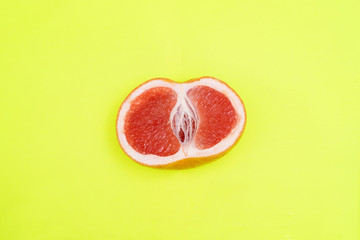 half a grapefruit on a bright yellow background