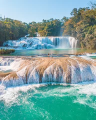  Couple contemplating the majestic turquoise waterfalls at Agua Azul in Chiapas, Mexico © JoseLuis