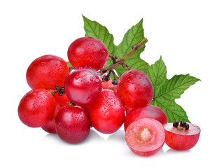 fresh red grapes with green leaves isolated on white background