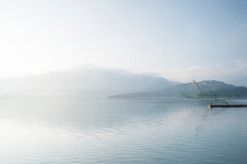 Plakat Landscape of famous Sun Moon Lake in the morning with a boat in Taiwan,