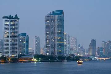 Skyscraper and building near river in Bangkok city.