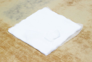 Sterile medical gauze on wood background