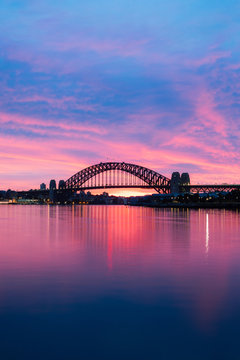 Silhouette Of Sydney Harbour Bridge At Dawn With Blue And Purple Sky.