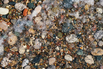 Stone natural background. Wet pebble stones in water.