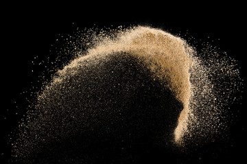 Sand flying explosion on black background ,throwing freeze stop motion object design - obrazy, fototapety, plakaty