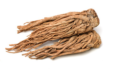 Angelica root used in chinese traditional herbal medicine, over white background. Radix angelicae sinensis