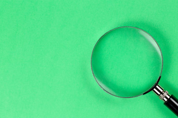 magnifying glass on green