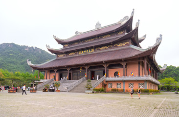 Fototapeta premium Ninh Binh, Vietnam - April 5th, 2019: Tam The Buddha's main architecture in Bai Dinh temple complex attracts tourists to visit, one of the largest in the south east asia in Ninh Binh, Vietnam