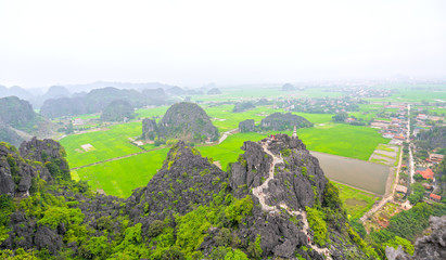 Ninh Binh, Vietnam - April 5th, 2019: Mua Cave mountain viewpoint, Stunning view of Tam Coc area with mountain range, rice fields. It is such as Great Wall in Ninh Binh, Vietnam