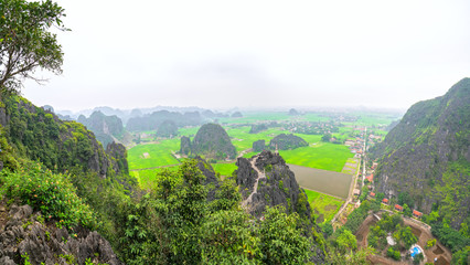 Ninh Binh, Vietnam - April 5th, 2019: Mua Cave mountain viewpoint, Stunning view of Tam Coc area with mountain range, rice fields. It is such as Great Wall in Ninh Binh, Vietnam