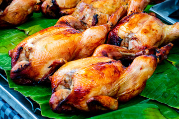 BAKE CHICKEN - STREET FOOD : BAKE WHOLE CHICKEN LAYING ON GREEN BANANA LEAF - HALAL FOOD
