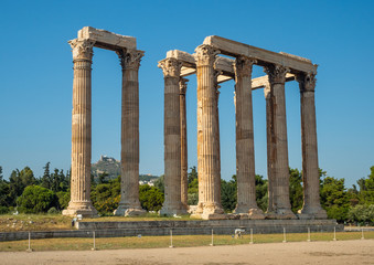 Fototapeta premium View of the ancient ruins and colonnade of Zeus Olympic Temple in Athens, Greece