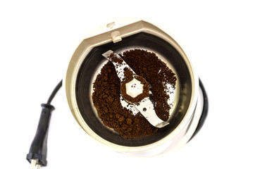 electric coffee grinder and coffee isolated on white background. View from above.