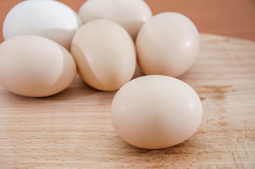 Chicken eggs on a wooden background. Close-up.