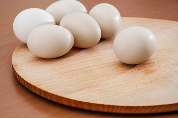 Chicken eggs on a wooden background. Close-up.
