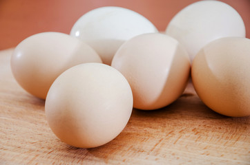 Chicken eggs on a wooden background. Close-up.