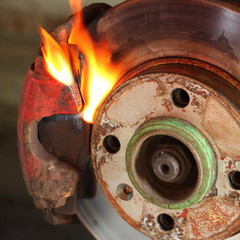 Overheated car brakes on fire - brake caliper jamming