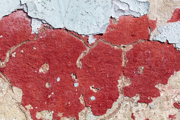 Concrete wall with cracked paint as abstract background