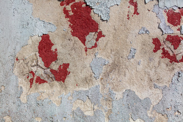 Concrete wall with cracked paint as abstract background