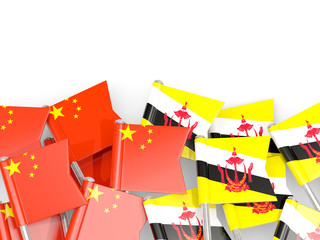 Pins with flags of China and brunei isolated on white.