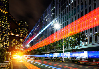 abstract image of blur motion of cars on the city road at night，Modern urban architecture