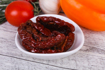Dried tomatoes in the bowl with olive oil