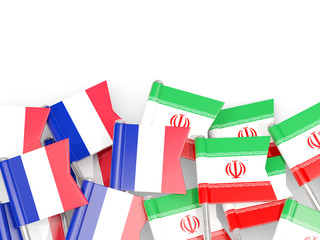 Pins with flags of France and iran isolated on white.