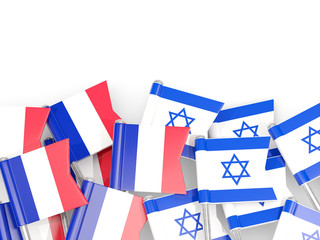 Pins with flags of France and israel isolated on white.