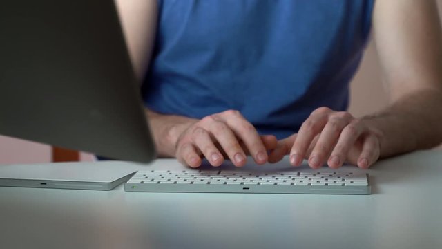 Close-up keyboard typing at the table. Man hands working at computer