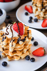 Waffles with berries and whipped cream