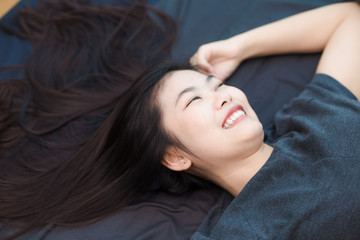 Beautiful asian long hair women lying on bed