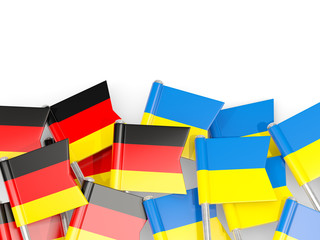Pins with flags of Germany and ukraine isolated on white.