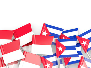 Pins with flags of Indonesia and cuba isolated on white.